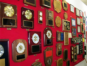 wall of awards and plaques at Dottie's Trophies Showroom in Laurel, Maryland